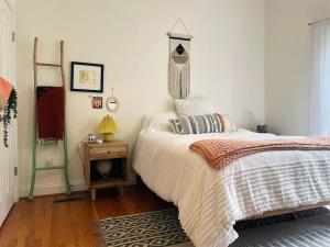 a bedroom with a bed and a table with a lamp at Peaceful 3BR on 5 acres - Minutes from Nashville in Joelton