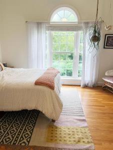 a bedroom with a bed and a large window at Peaceful 3BR on 5 acres - Minutes from Nashville in Joelton