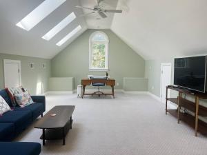 a living room with a blue couch and a piano at Peaceful 3BR on 5 acres - Minutes from Nashville in Joelton