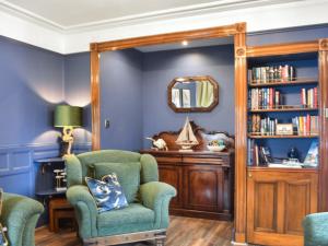 a living room with a chair and a mirror at Going Coastal in Inverallochy