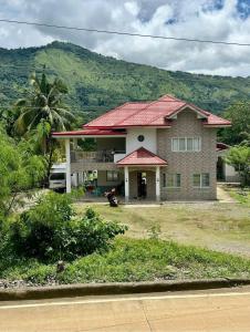 a house with a mountain in the background at The Meadow View House in Oobi