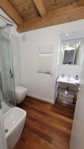 a bathroom with a sink and a toilet and a mirror at Little Apartment in Potenza