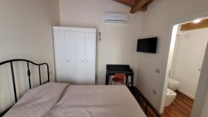 a bedroom with a bed and a bathroom with a toilet at Little Apartment in Potenza