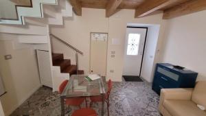 a living room with a glass table and stairs at Little Apartment in Potenza +8 photos