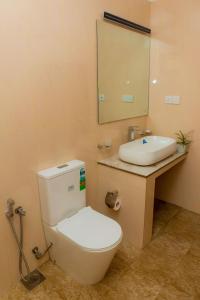 a bathroom with a toilet and a sink at Shasha House Bentota in Hettiwatta +32 photos