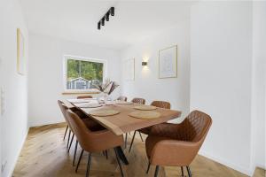 a dining room with a wooden table and chairs at Luxury house with exclusive views in Vallendar