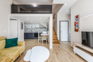 a living room with a couch and a table at Luma Penthouses by Kondo Stays in Tirana
