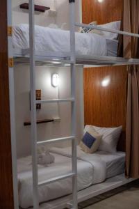 a couple of bunk beds in a room at Sanga Rooftop Hostel in Pakse +26 photos
