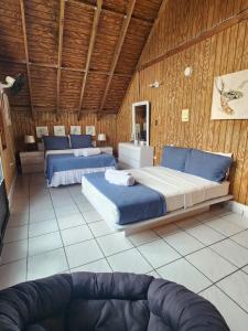 a bedroom with two beds and a couch in it at Casa Campo Obymar/vista panorámica/piscina privada in Moca +85 photos