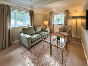 a living room with a couch and a table at Pine View - Uk50699 in St Margarets at Cliff