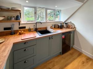 a kitchen with a sink and a counter top at Pine View - Uk50699 in St Margarets at Cliff