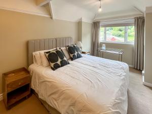 a bedroom with a large white bed with pillows at Pine View - Uk50699 in St Margarets at Cliff +3 photos