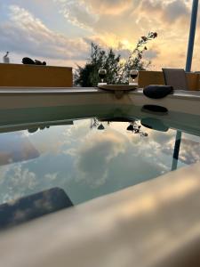 a reflection of the sky in the roof of a car at Villa Bonita Private Traditional house in Kamari