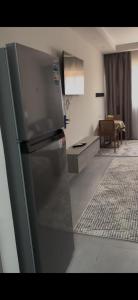 a kitchen with a refrigerator and a living room at غرفه فندقيه in Hurghada