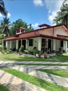 a house with a pathway in front of it at Airport Dulux Green Villa in Minuwangoda