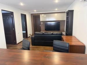 a living room with a couch and a flat screen tv at Self-Contained Studio in Loganholme +3 photos