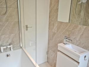 a bathroom with a shower and a sink and a mirror at Gracelands in Uny Lelant +16 photos
