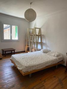 奥塞雅Casa Osseja的一间卧室，里面有一张床和两个梯子。