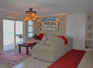 a living room with a white couch and a table at C 4Ever Unit 1 and 2 in Groot Brak Rivier