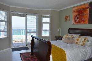 a bedroom with a bed with a teddy bear on it at C 4Ever Unit 1 and 2 in Groot Brak Rivier +15 photos