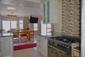 a kitchen with a stove and a dining room at C 4Ever Unit 1 and 2 in Groot Brak Rivier