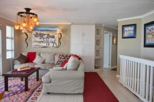 a living room with a white couch and a red rug at C 4Ever Unit 1 and 2 in Groot Brak Rivier