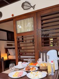 a table with plates of food on top of it at Pousada Aky Jeri in Jericoacoara