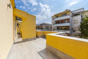 a view from the balcony of a yellow building at Luma Penthouses by Kondo Stays in Tirana