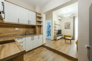 a kitchen with white cabinets and a desk at Luma Penthouses by Kondo Stays in Tirana