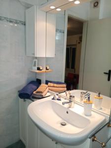 a bathroom with a white sink and a mirror at Angelo Home in Genova