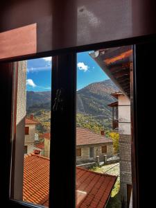 a view from a window looking out at a mountain at MetsoVillas στο κέντρο του Μετσόβου in Metsovo