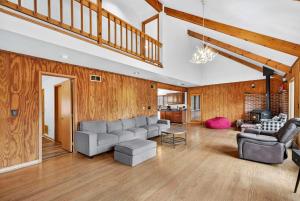 a living room with a couch and a table at Huge Cabin w Hot Tub, Deck, Grill, Fire Pit, WiFi in Berkeley Springs +70 photos