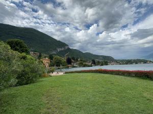 a grassy field next to a body of water at Vener Appartament - A due passi dal Lago in Ossuccio