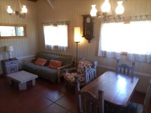 a living room with a couch and a table at Casa de Campo Meliquina in Lago Meliquina