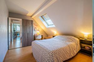 a bedroom with a bed and a skylight at Castle view terrace - Swimming pool - Air conditioning in La Vancelle