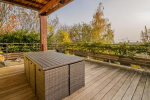 a wooden deck with a trashcan on top of it at Castle view terrace - Swimming pool - Air conditioning in La Vancelle