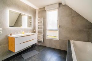 a bathroom with a sink and a mirror at Castle view terrace - Swimming pool - Air conditioning in La Vancelle