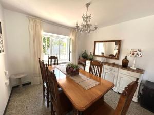 a dining room with a wooden table and chairs at Casa Pancha in Ribadeo +6 photos