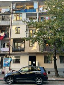 a black car parked in front of a building at Tamara in Batumi +4 photos