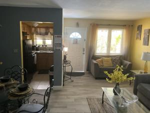 a living room with a couch and a table at Jubilee Gardens Freeport in Freeport