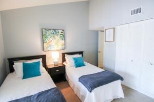 two beds in a room with blue and white at Tranquil condo minutes from Venice Beach - Beach Bungalow in Nokomis +34 photos