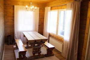 a wooden table and bench in a room with a window at Private Villa At Lake  +16 photos