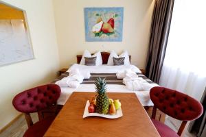 a hotel room with a table with a pineapple on it at VULKAN Residenz Hotel I Self Check-in in Leibnitz +18 photos