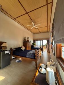 a bedroom with a bed and a table at Kampung Kecil Beach Front Boutique Hotel in Kubu +42 photos