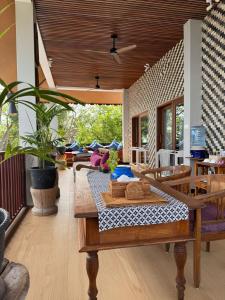 a living room with a table and chairs at Kampung Kecil Beach Front Boutique Hotel in Kubu