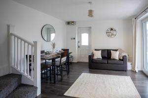 a living room with a table and a couch at Comfortable Home Near Supermarket with Parking & Garden in Bullingham