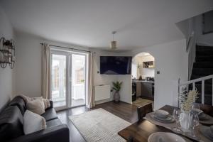 a living room with a couch and a table at Comfortable Home Near Supermarket with Parking & Garden in Bullingham
