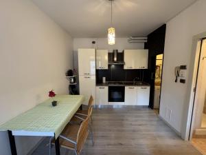 a kitchen and dining room with a table and chairs at Luca's Home - a due passi dal Centro Storico in Como +11 photos