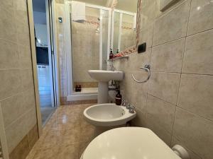 a bathroom with a white toilet and a sink at Luca's Home - a due passi dal Centro Storico in Como