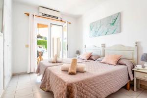 a bedroom with two beds with pink pillows at Villa Mencia by Villa Plus in S'Algar +19 photos